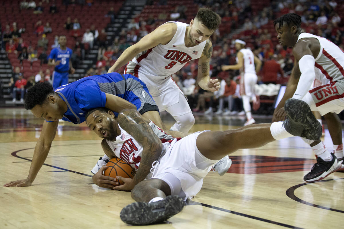 UNLV Rebels forward Royce Hamm Jr. (14) and Air Force Falcons guard A.J. Walker (10) compete fo ...