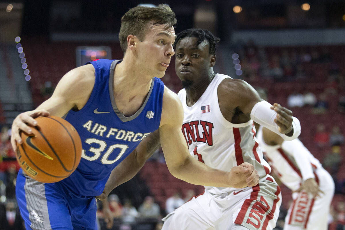 Air Force Falcons guard Camden Vander Zwaag (30) drives around UNLV Rebels guard Michael Nuga ( ...