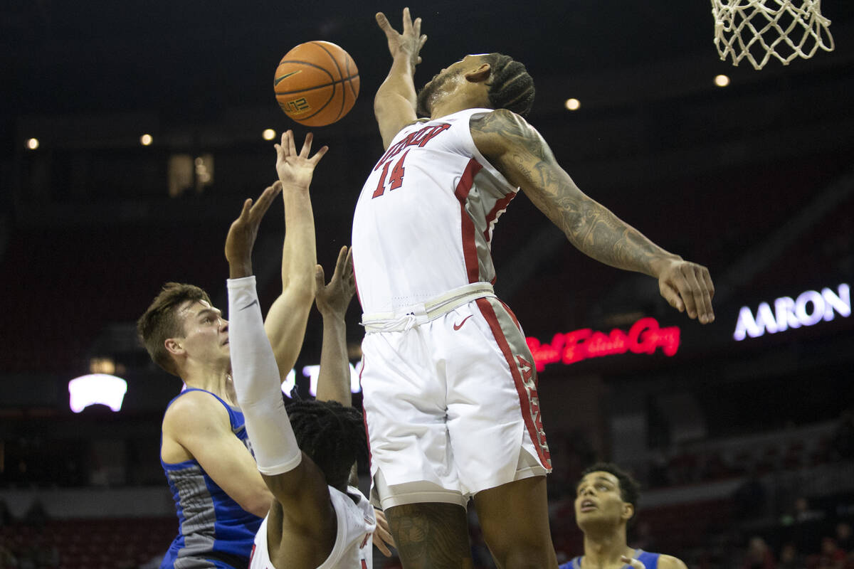 UNLV Rebels forward Royce Hamm Jr. (14) blocks a shot by Air Force Falcons guard Camden Vander ...