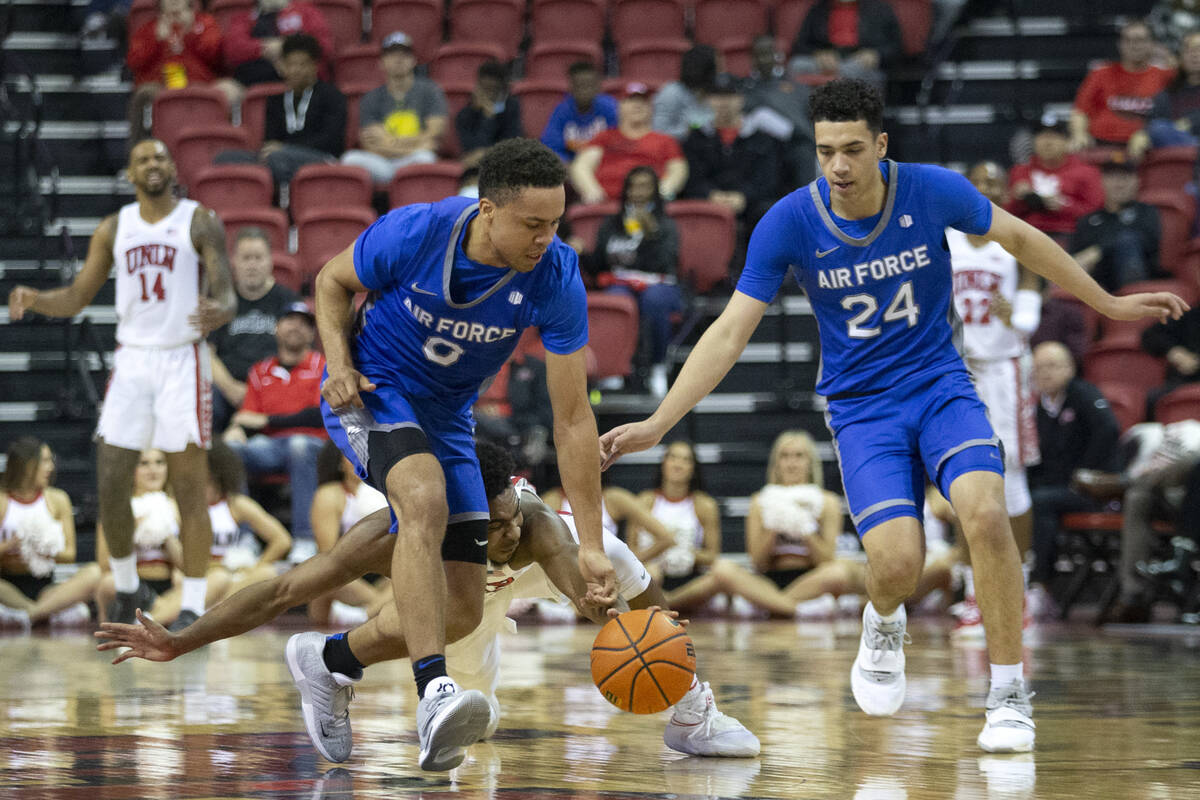 UNLV Rebels guard Bryce Hamilton (13) dives for the ball behind Air Force Falcons guard Joseph ...