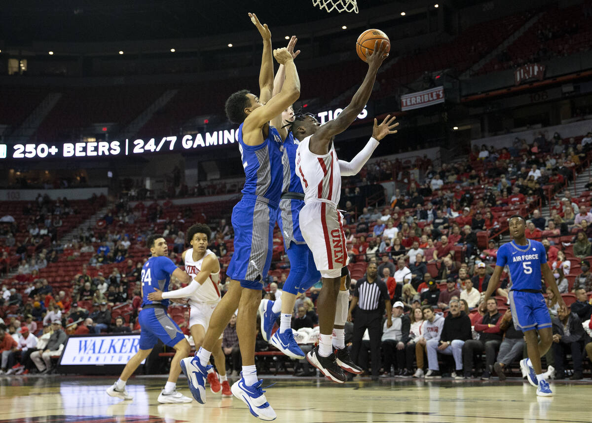 UNLV Rebels guard Michael Nuga (1) shoots against Air Force Falcons forward Nikc Jackson (22), ...