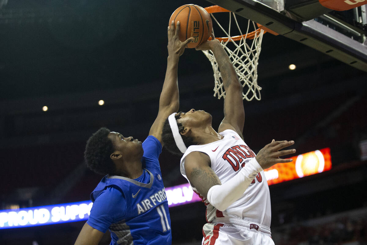 UNLV Rebels guard Keshon Gilbert (10) shoots against Air Force Falcons guard Byron Brown (11) d ...