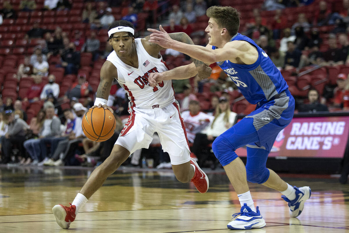 UNLV Rebels guard Keshon Gilbert (10) dribbles around Air Force Falcons center Lucas Moerman (3 ...