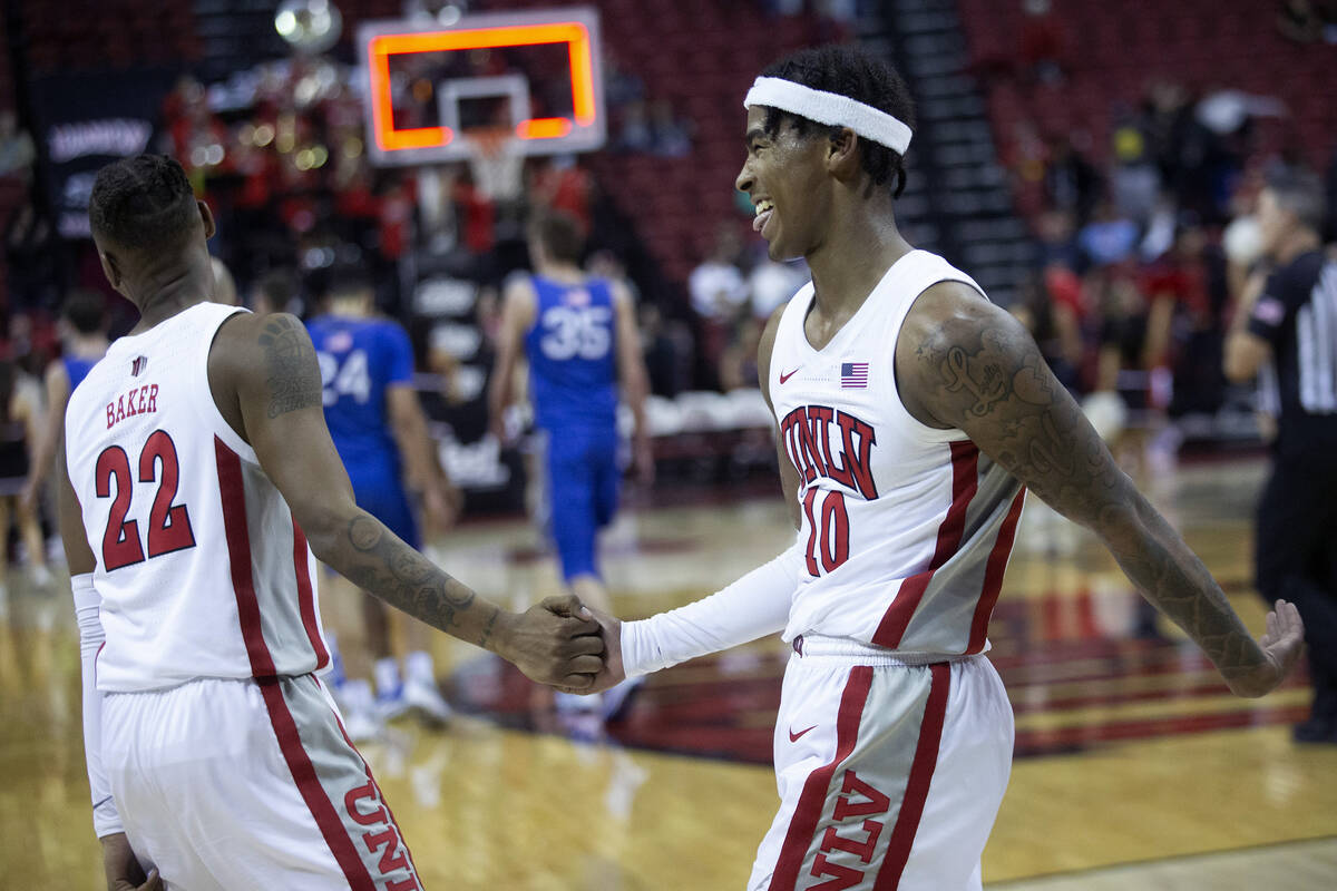 UNLV Rebels guard Keshon Gilbert (10) and guard Josh Baker (22) celebrate after winning an NCAA ...