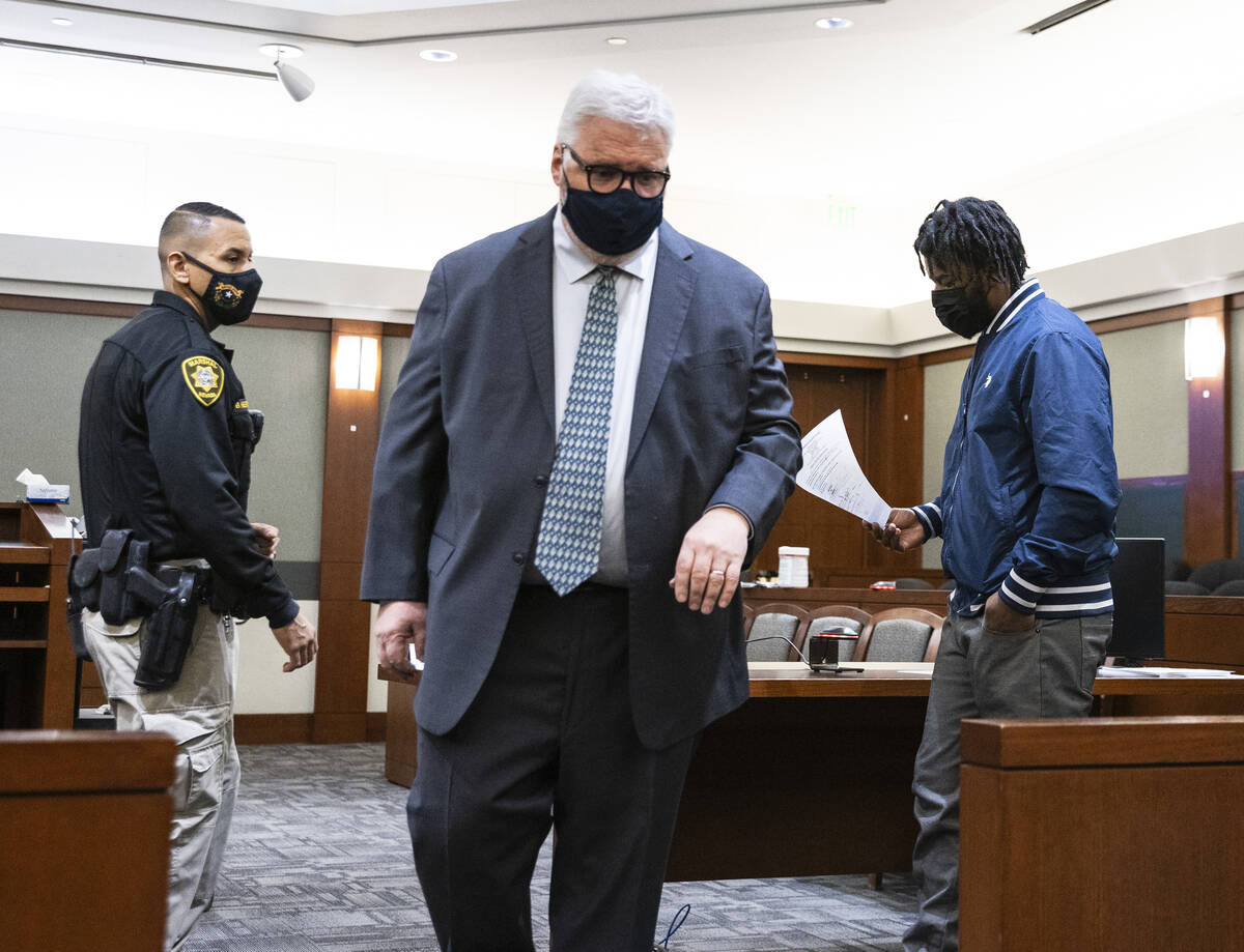 Luther Childers, right, arrested in his 2-month-old’s death, leaves the courtroom with h ...