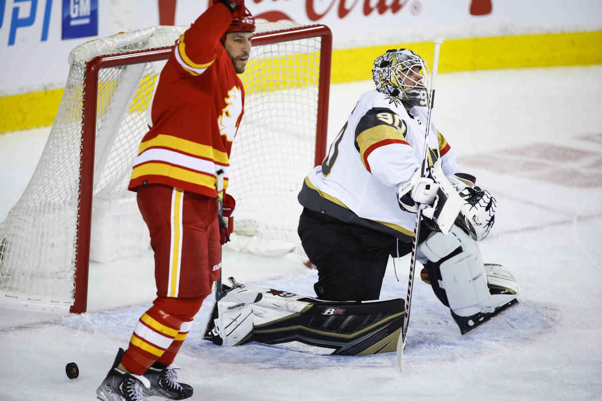 Vegas Golden Knights goalie Robin Lehner, right, looks away as Calgary Flames' Milan Lucic cele ...