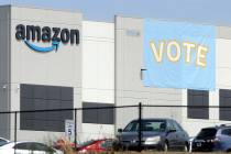 FILE - A banner encouraging workers to vote in labor balloting is shown at an Amazon warehouse ...