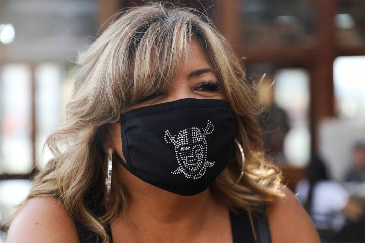 Rosemary Gonzales shows off her Raiders mask at PKWY Tavern ahead of the Raiders first home gam ...