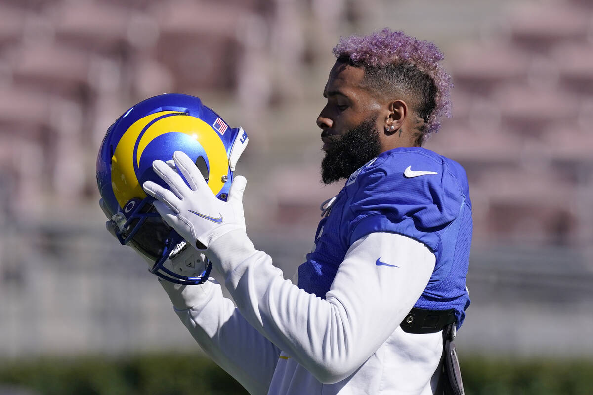 Los Angeles Rams wide receiver Odell Beckham Jr. puts on his helmet during practice for an NFL ...