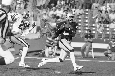 In this Saturday, Jan. 8, 1983 file photo, Raiders wide receiver Cliff Branch, right, catches a ...