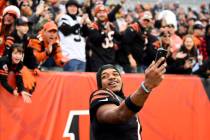 FILE - Cincinnati Bengals wide receiver Ja'Marr Chase (1) takes a video with fans in the backgr ...