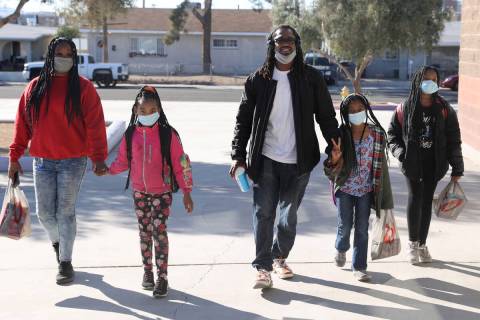 Kendrick Belford and his wife Daneah drop off their daughters, from left, Jay’moni, 8, N ...