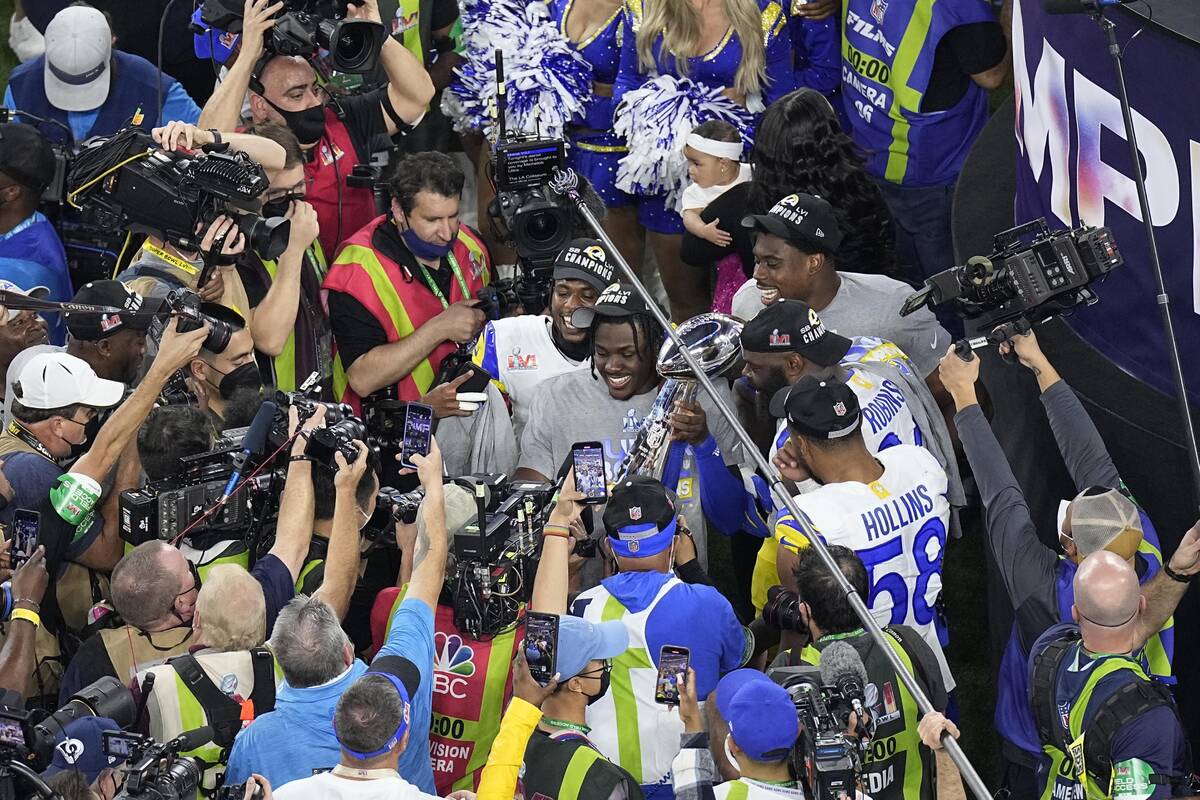 Los Angeles Rams players hold the Vince Lombardi trophy after the team won the NFL Super Bowl 5 ...