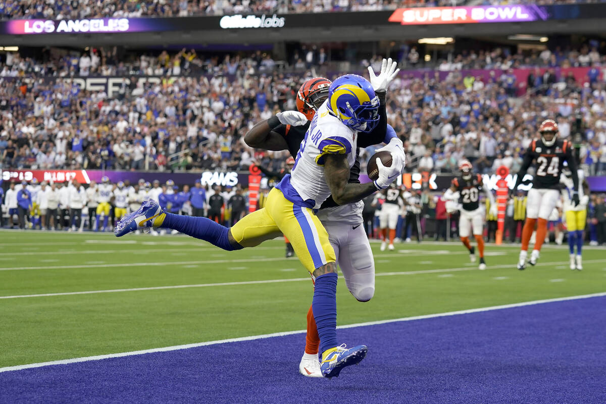 Los Angeles Rams wide receiver Odell Beckham Jr., foreground, catches a touchdown pass in the e ...