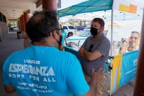 Arizona Democrat Rep. Ruben Gallego, right, talks with Jose Marquez, left, of UnidosUS, at an i ...