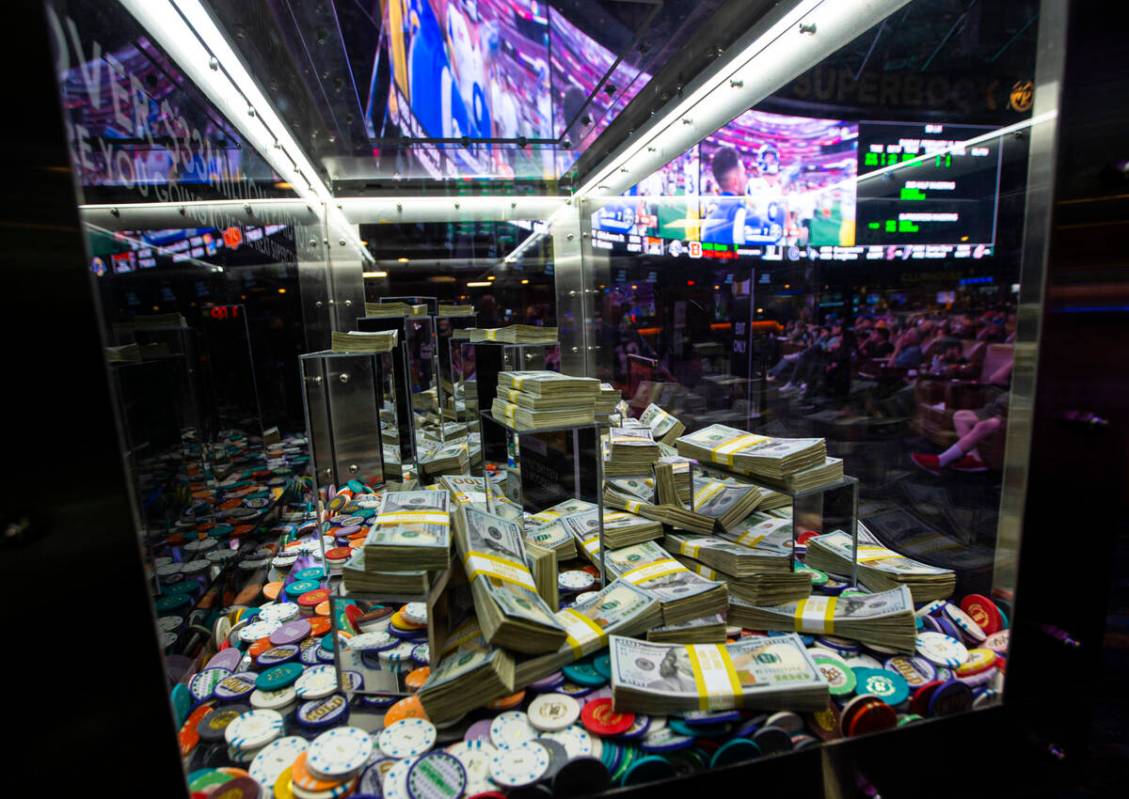 Promotional money and chips are displayed as attendees take in the action during a Super Bowl w ...