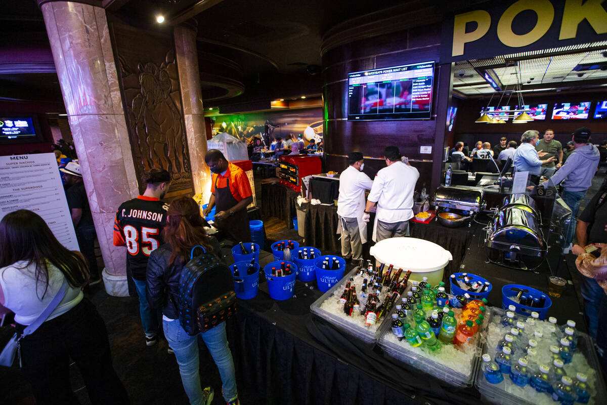 Attendees get drinks during a Super Bowl watch party at the Westgate SuperBook on Sunday, Feb. ...
