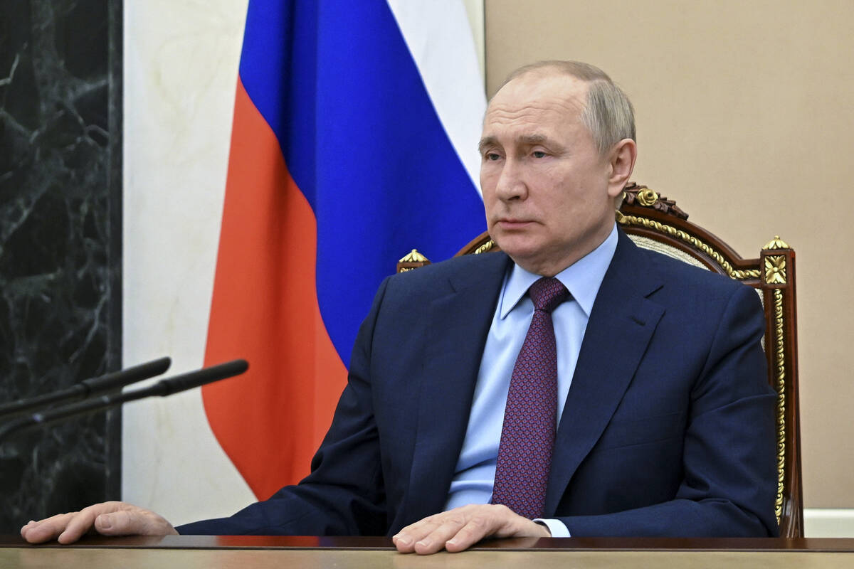 Russian President Vladimir Putin listens to Russian Russian Defense Minister Sergei Shoigu duri ...