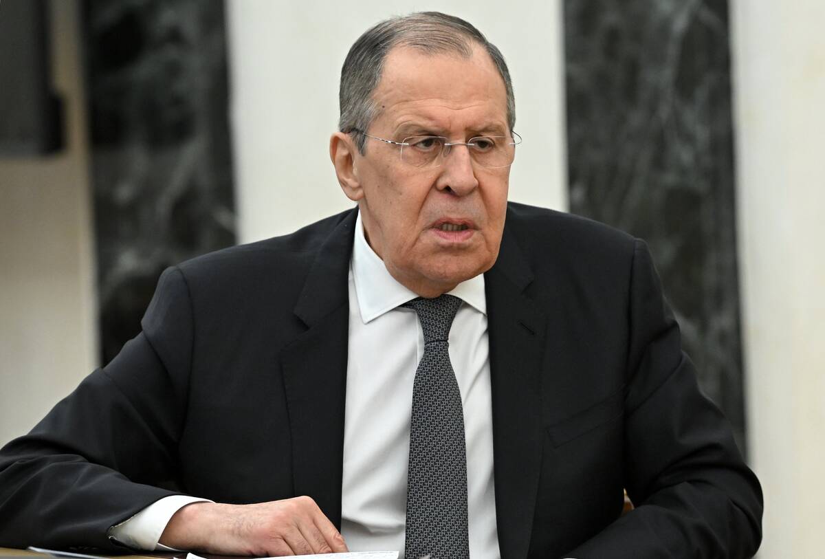 Russian Foreign Minister Sergey Lavrov speaks to Russian President Vladimir Putin during their ...