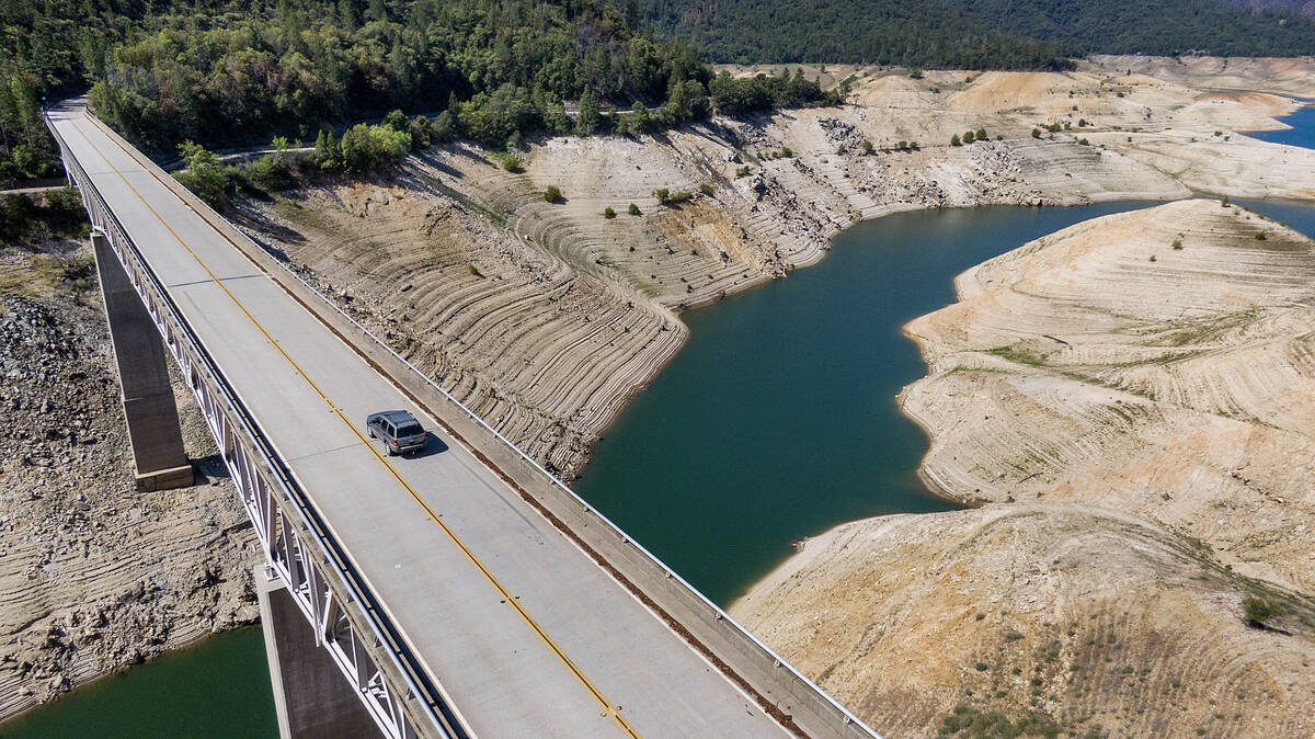 A car crosses Enterprise Bridge over Lake Oroville's dry banks on May 23, 2021, in Oroville, Ca ...