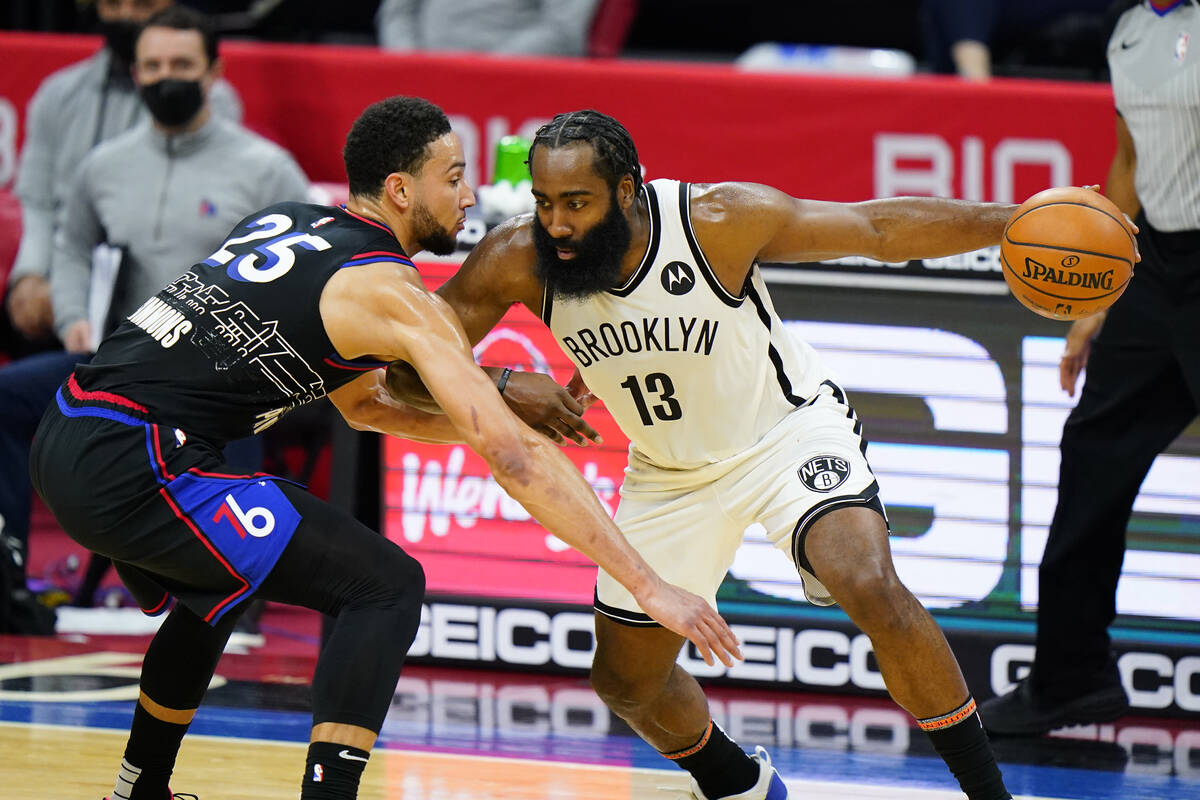 FILE - Brooklyn Nets' James Harden (13) tries to drive past Philadelphia 76ers' Ben Simmons (25 ...