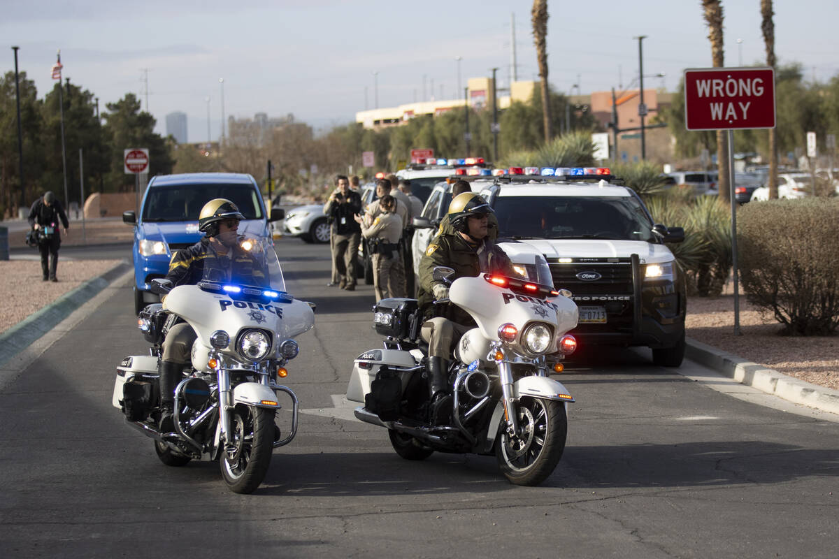 A police escort leads the way for retired Las Vegas police officer Herman Moody, 97, and his fa ...