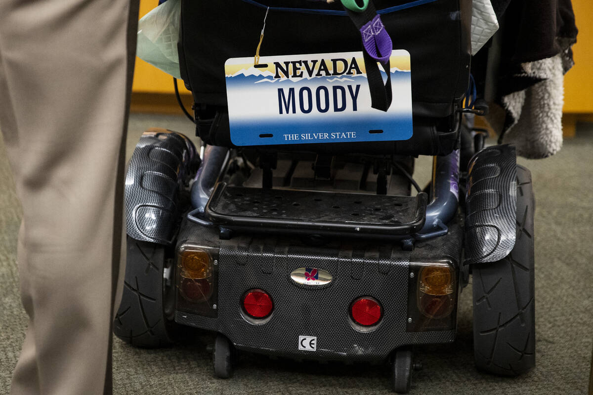 Retired Las Vegas police officer Herman Moody, 97, displays a license plate on his wheel chair ...