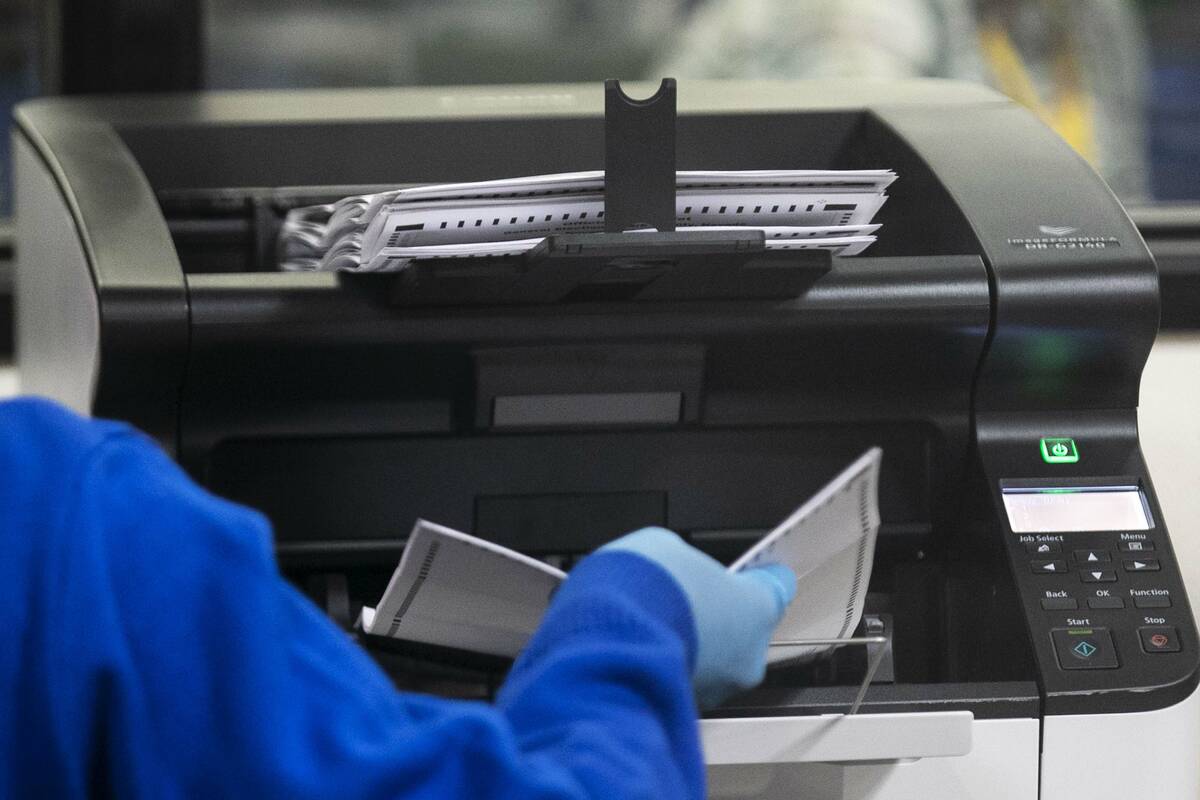 A Clark County election worker scans ballots at the Election Department warehouse, on Tuesday, ...