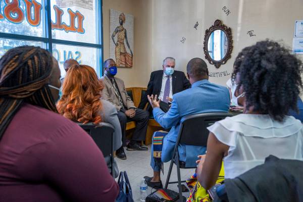 Gov. Steve Sisolak , center, listens to an introduction as he meets with Black business owners ...