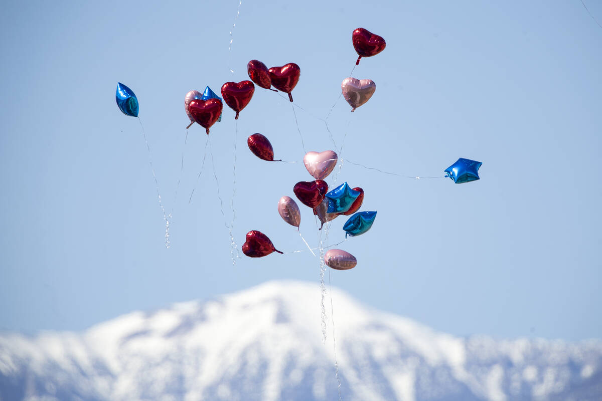 Balloons are released during the memorial service for the Zacarias family, 7 of whom were kille ...
