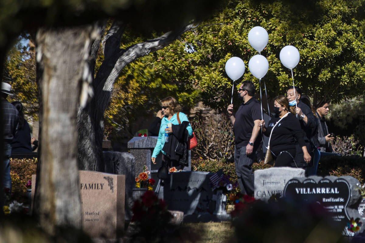 Mourners attend the service and burial of members of the Zacarias family who were killed in a c ...