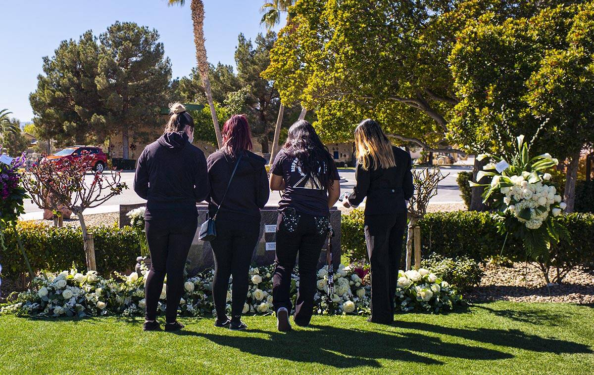 Mourners visit the burial site of the five Zacarias family members that were buried earlier in ...