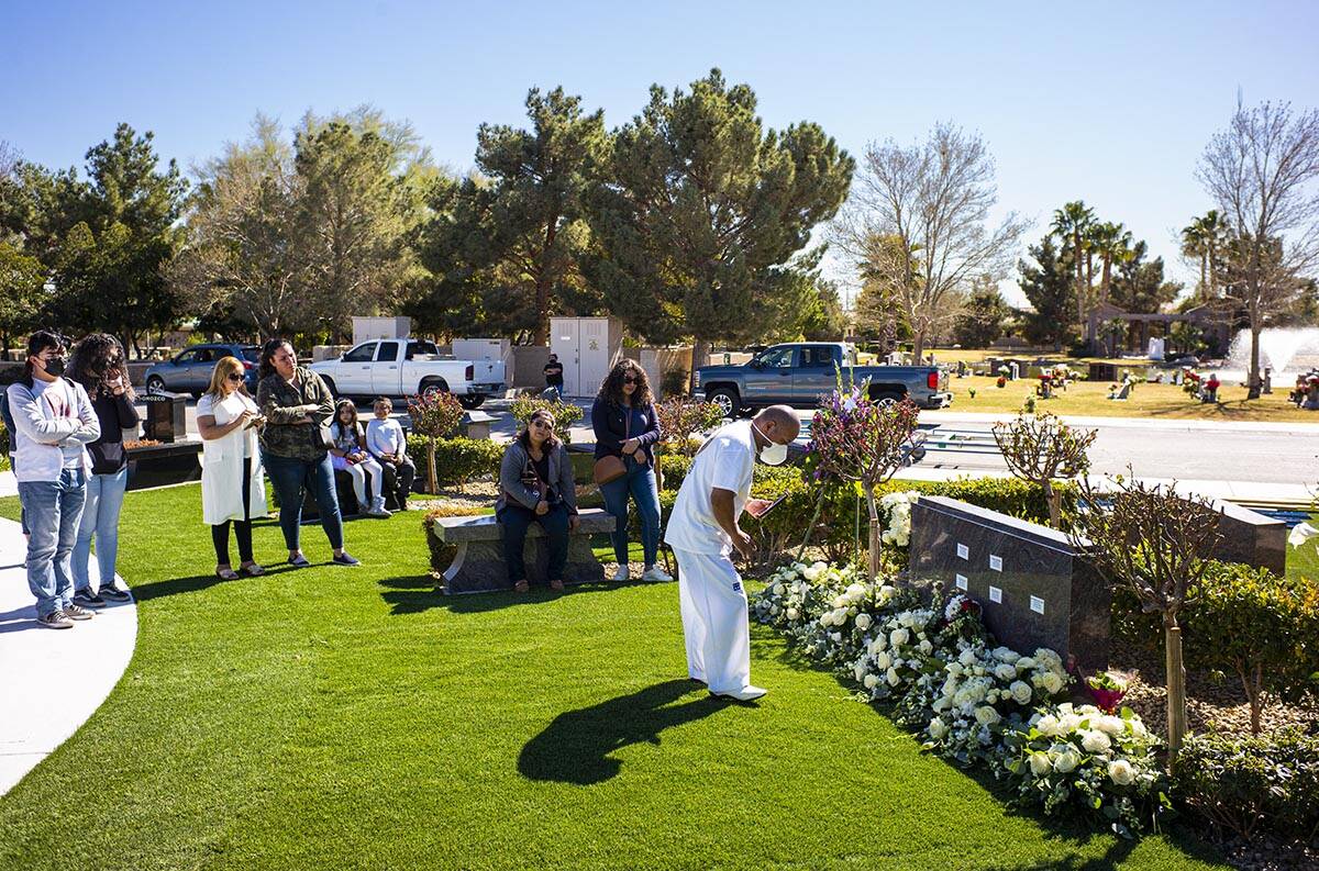 Mourners visit the burial site of the five Zacarias family members that were buried earlier in ...