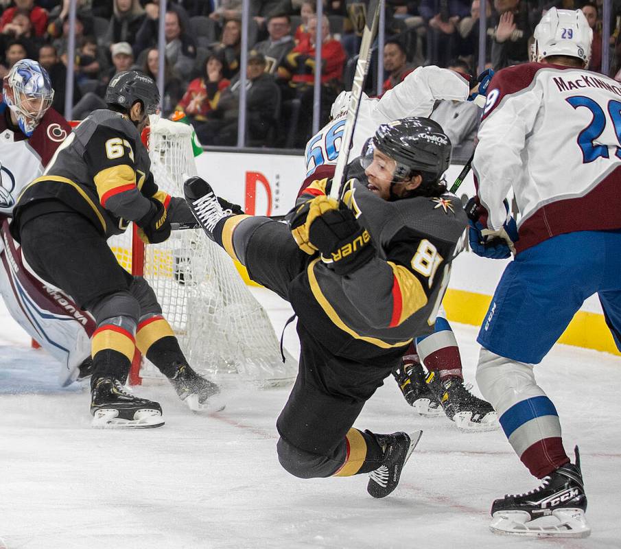 Golden Knights center Jonathan Marchessault (81) is hit by Colorado Avalanche center Nathan Mac ...