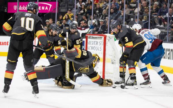 Golden Knights goaltender Laurent Brossoit (39) makes a save against Colorado Avalanche right w ...