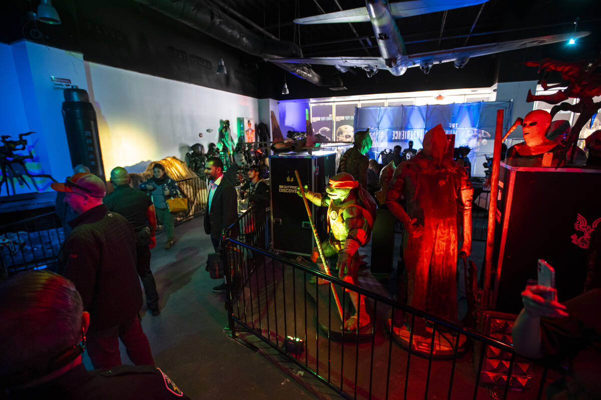 People explore The Movie Prop Experience during a preview at Neonopolis on Fremont Street Thurs ...