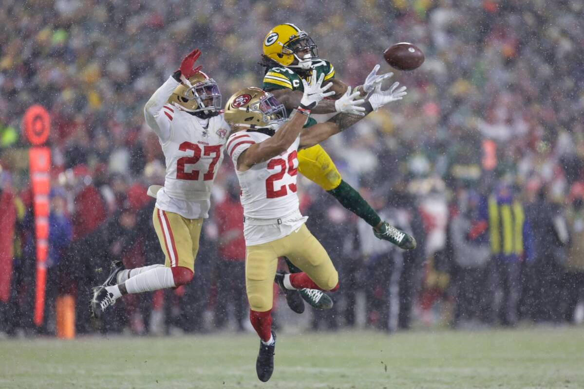 San Francisco 49ers' Talanoa Hufanga and Dontae Johnson break up a pass intended for Green Bay ...