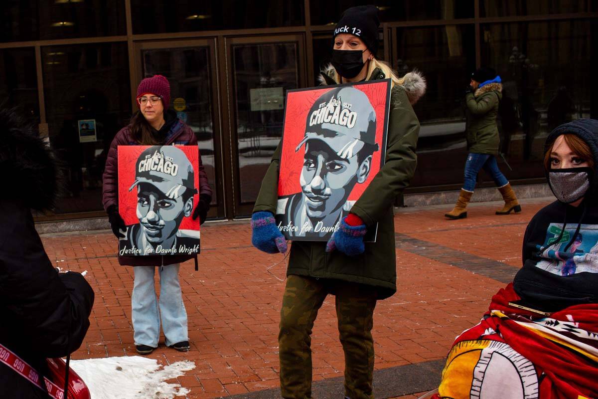 Demonstrators hold Justice for Daunte Wright signs Friday, Feb. 18, 2022 in Minneapolis. Former ...
