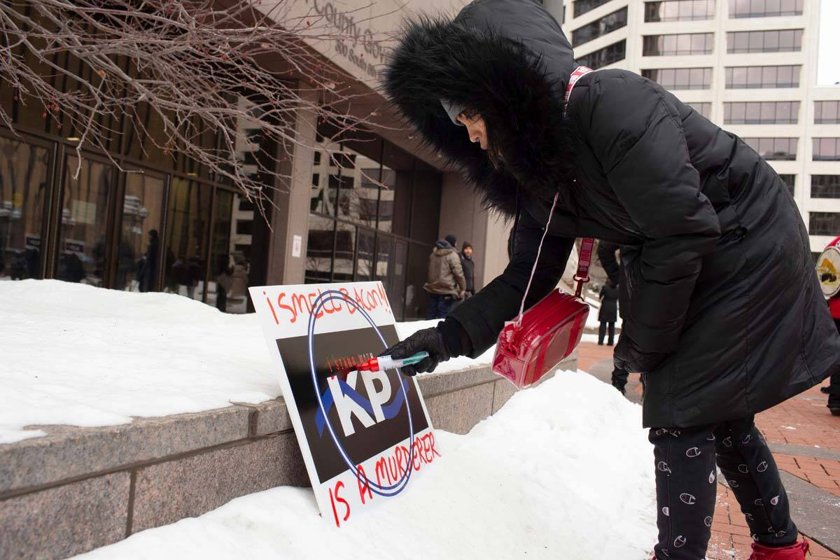 Nae Totushek writes on a I Stand With Kim Potter sign Hennepin County Government Center calling ...