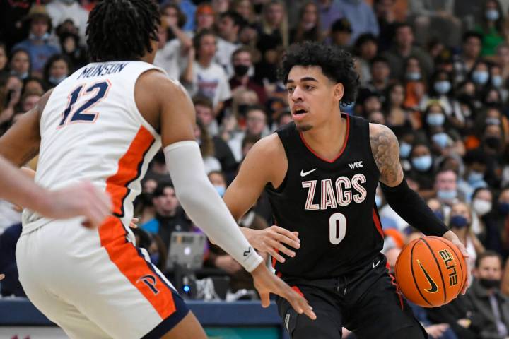 Pepperdinevforward Kendall Munson (12) guards Gonzaga guard Julian Strawther (0) during an NCAA ...