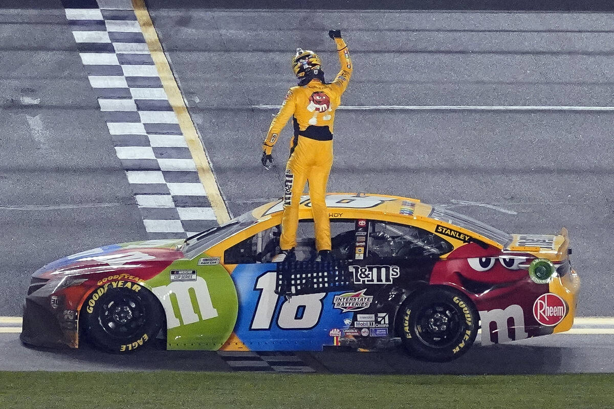 Kyle Busch celebrates on the top of his car after winning the NASCAR Clash auto race at Daytona ...