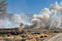 This photo shows smoke and fire from a wildfire near in Owens Valley, Calif. on Thursday, Feb. ...