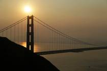 Smoke from wildfires obscures the San Francisco skyline behind the Golden Gate Bridge Friday, N ...