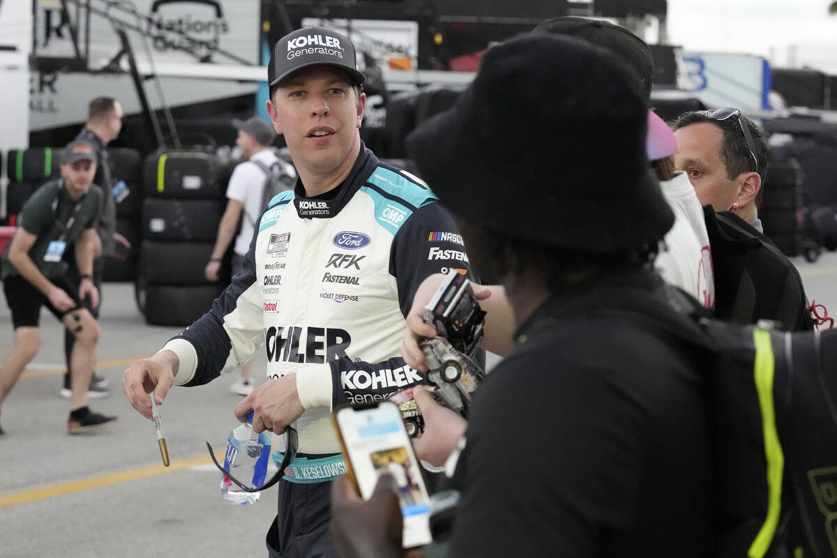 Brad Keselowski talks to fans after NASCAR Daytona 500 auto race practice Friday, Feb. 18, 2022 ...