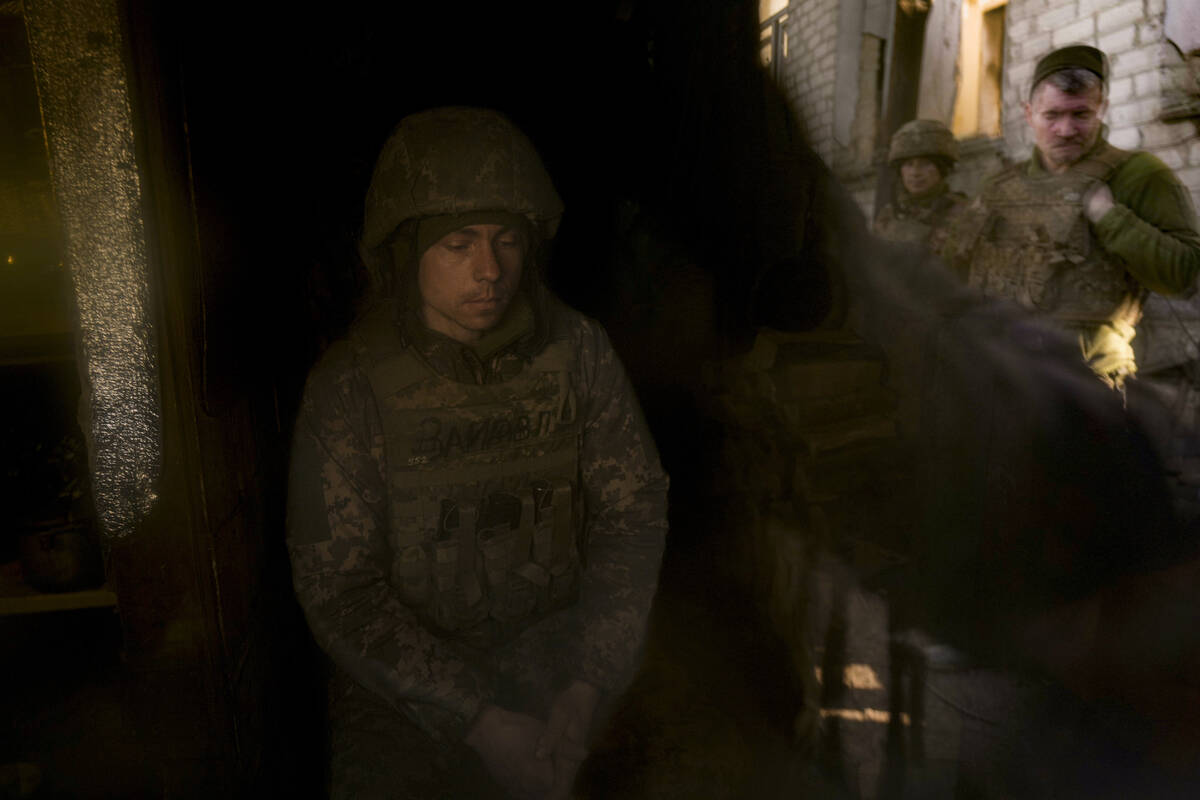 A Ukrainian serviceman sits in an observation point near the frontline village of Krymske, Luha ...