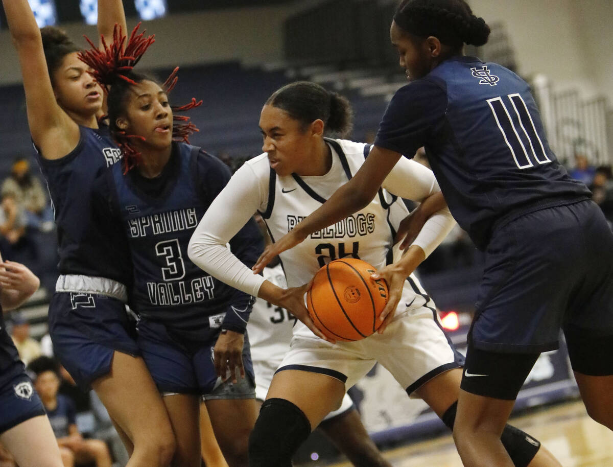 Centennial High School's Kennedy Lee (24) keeps a ball away from Spring Valley High School's Ja ...