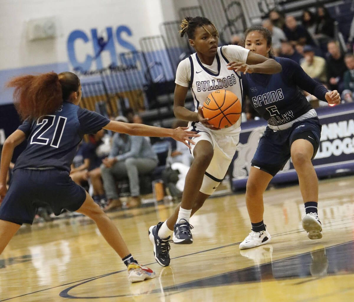 Centennial High School's Kaniya Boyd (00), center, tries to drive past Spring Valley High Schoo ...