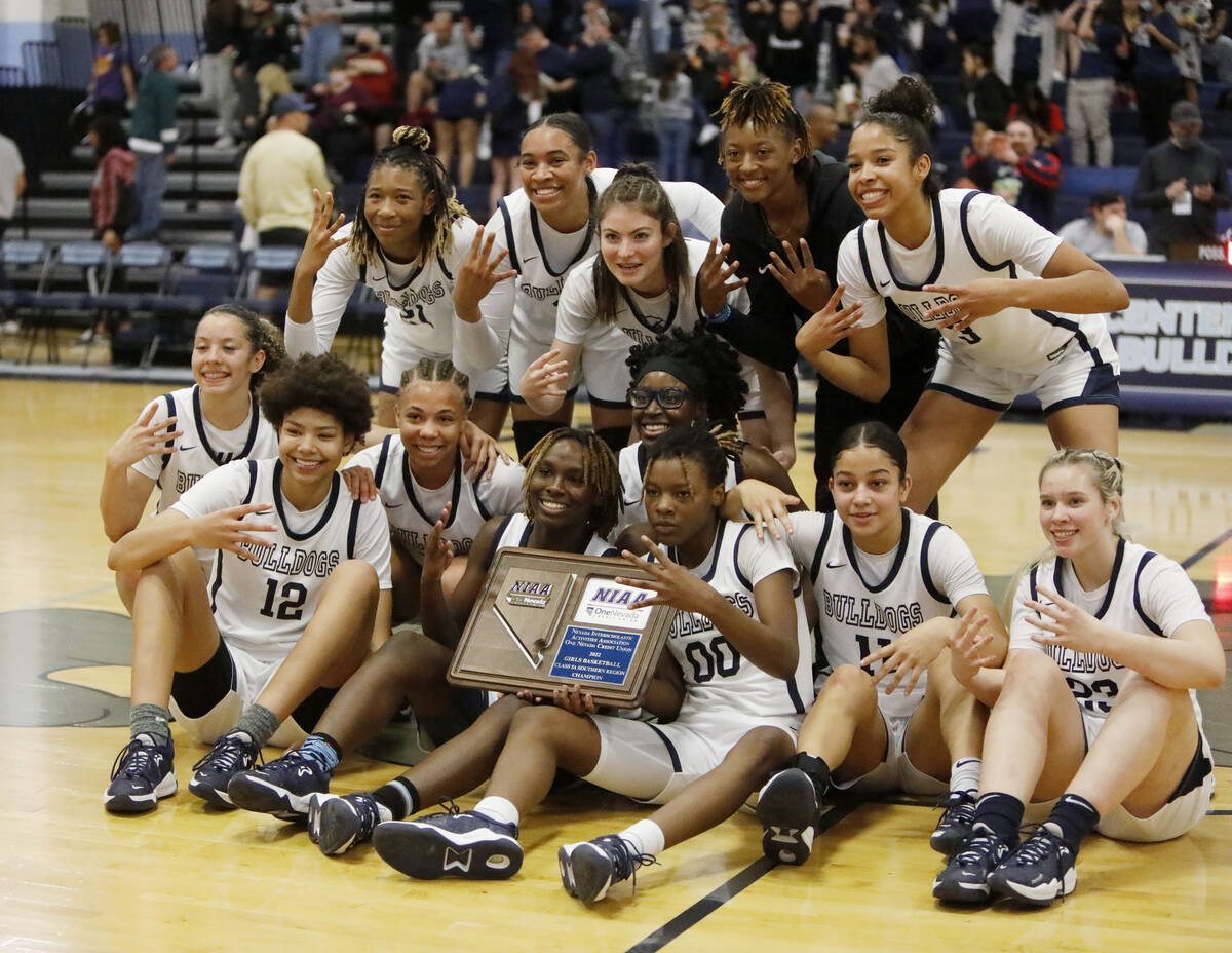 Centennial High School players pose for a photo after their victory against Spring Valley High ...