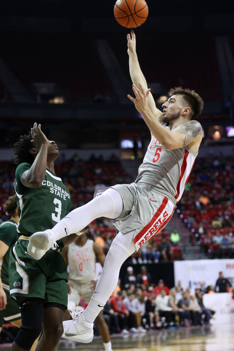 UNLV’s Jordan McCabe (5) shoots the ball under pressure from Colorado State’s Ken ...