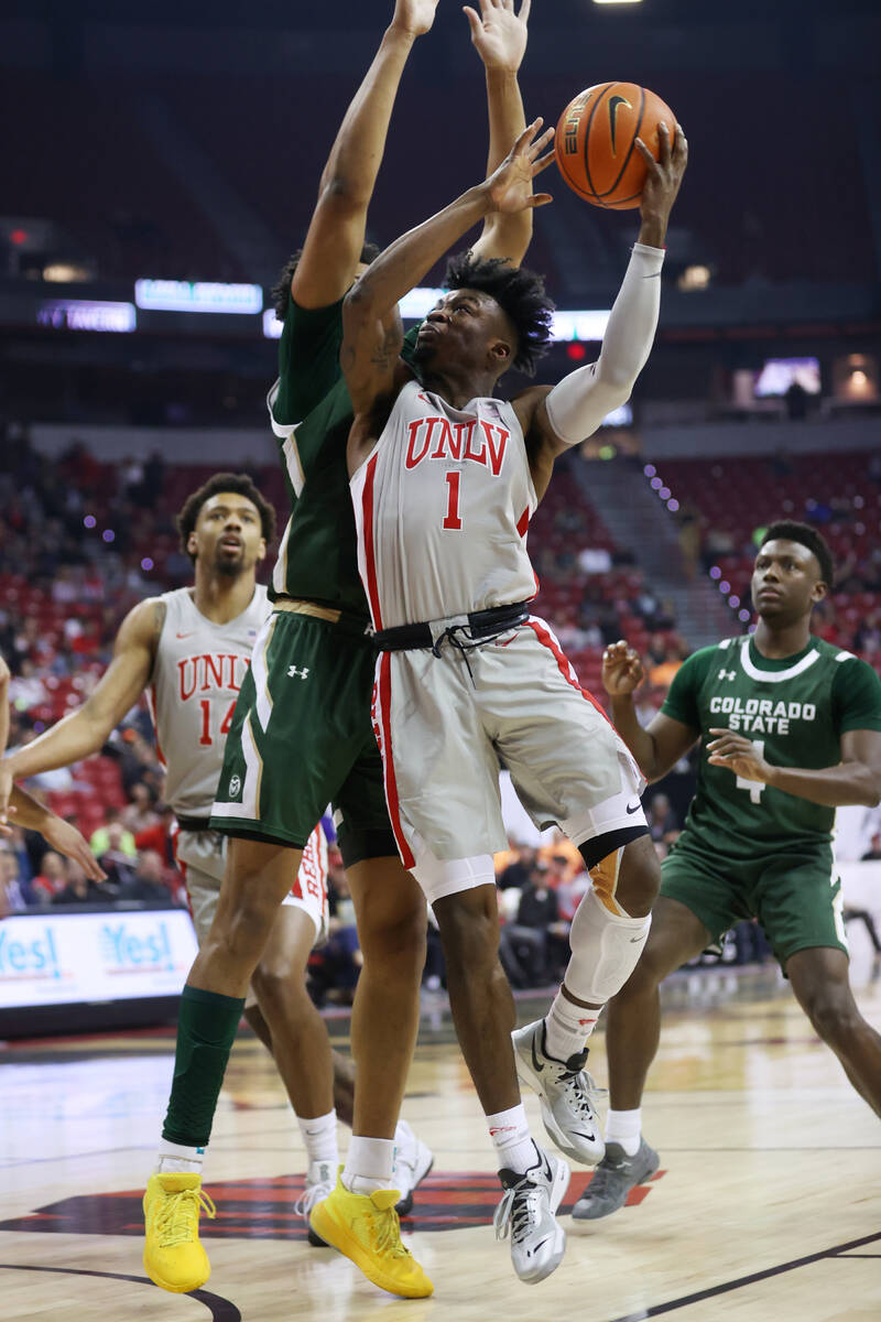 UNLV’s Michael Nuga (1) goes up for a shot against Colorado State’s Dischon Thoma ...